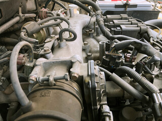 Car gasoline engine photo. Car engine part. Close-up image, internal combustion engine, used car, natural light.