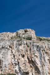 Scenic landscape of white rock at sunny summer day. Beautiful nature in Greece. Huge mountain.