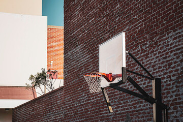 Urban basketball hoop and brick wall