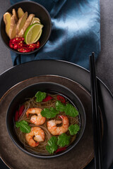 Asian soup with noodles, shrimps,coriander,ginger,chili.Traditional asian food..