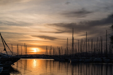 Fototapeta premium Yacht and boats parking in harbor. White sailing yachts at the pier. Sea yacht club. Aegean sea. Athens, Greece. Sunset sky.