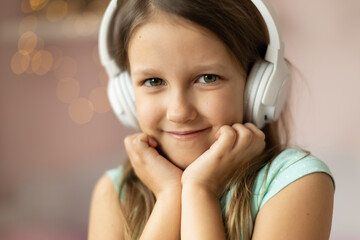 girl child listening to music with headphones