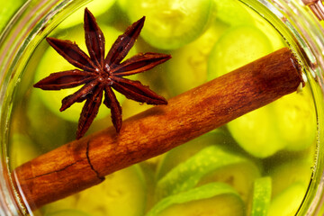 Star anise and Ceylon cinnamon macerating in alcohol with unripe walnuts, to prepare nut liqueur