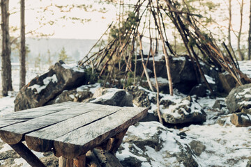 homemade table in the forest for travelers against the background of the hut. homemade table from boards in the forest