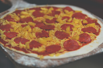 Peperoni.Wood-fired pizza. Pizza preparation in restaurant. Ketchup. kneading pizza. kiln. placing ingredients, tomato, cheese, mushroom, black olive, pepperoni, ham and peppers.