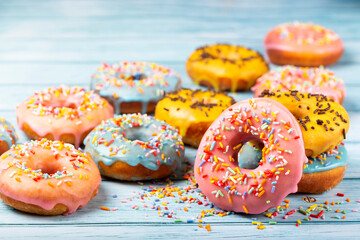 Delicious assorted colorful donuts on the table.