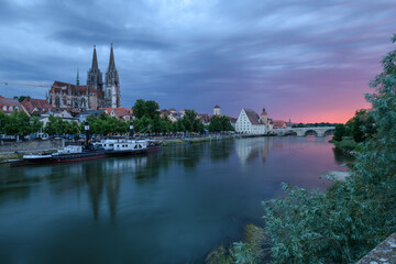 Fototapeta na wymiar Regensburg am Abend bei Dämmerung mit Dom, steinerner Brücke und Donau