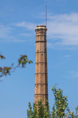 Old industrial chimney of the old pottery factory in Segovia, next to the Eresma river, now inhabited by storks