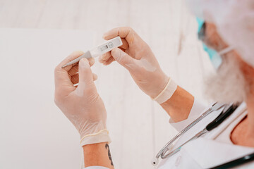 Doctor is checking the covid 19 with a thermometer