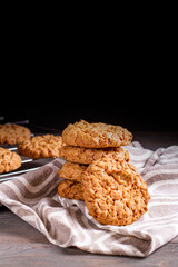 A stack of oatmeal cookies in a saucer on a wooden table