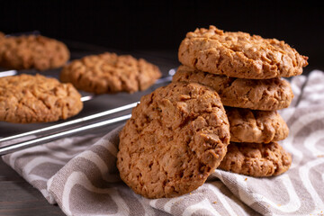 A stack of oatmeal cookies in a saucer on a wooden table