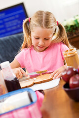 Student: Little Girl Making Her Own School Lunch