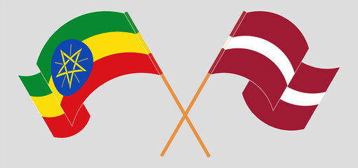 Crossed and waving flags of Ethiopia and Latvia