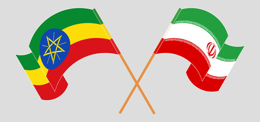 Crossed and waving flags of Ethiopia and Iran
