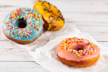 Delicious assorted colorful donuts on the table.