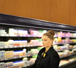 Woman choosing a dairy products at supermarket