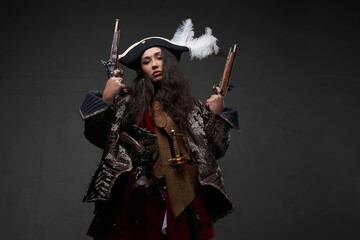 Barbaric woman pirate holding dual flintlock pistols