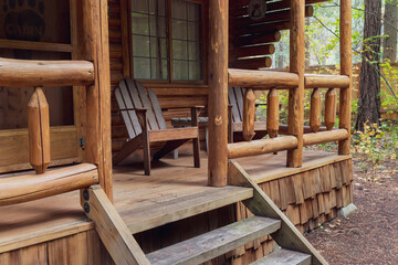 View of Front Porch of Rustic Log Cabin in the Woods - obrazy, fototapety, plakaty