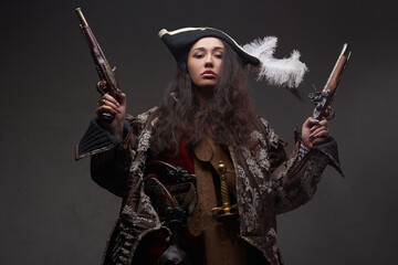 Fototapeta premium Brunette caribbean corsair with dual flintlock guns
