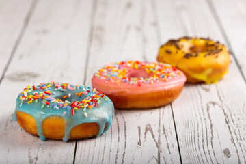 Delicious assorted colorful donuts on the table.