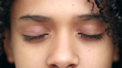 Contemplative black girl closing and opening eyes in meditation