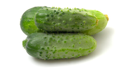 Three green gherkin cucumbers isolated on white background.