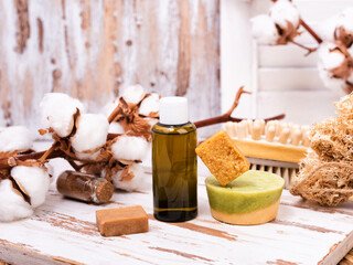 Solid bars of organic shampoo and bottle of shower gel.