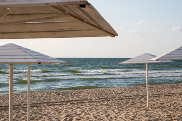 empty beach with wooden umbrellas
