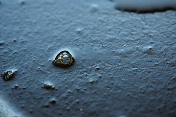 black old frying pan with oil drops close-up