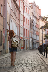 Fototapeta premium a girl walks through the streets of an old European city