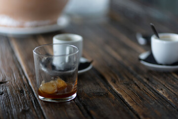 woman with rings and watch having a cup of coffee at wooden table
