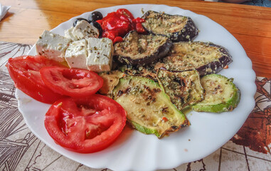 Healthy salad with fresh vegetables on wooden background,Greek salad of organic vegetables with tomatoes, red onion, olives and feta cheese