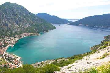 Bay of Kotor, view from above. You can see the vast Adriatic Sea and the town of Risan, which are surrounded by rocky mountains.
