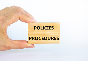 Policies and procedures symbol. Wooden blocks with concept words Policies procedures on white background. Businessman hand. Business and policies and procedures concept. Copy space.