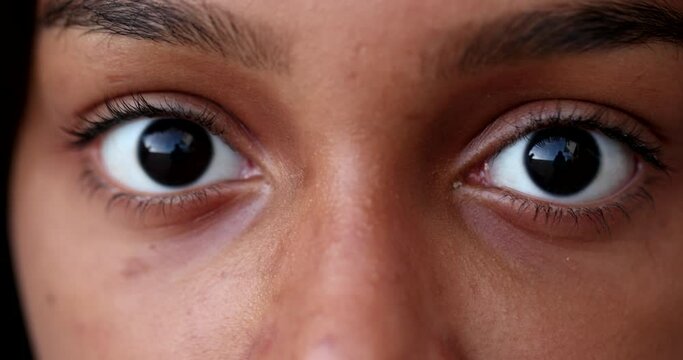 Black child eyes wide open looking at camera macro close-up