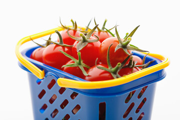 Fototapeta na wymiar cherry tomatoes in a shopping basket, white background
