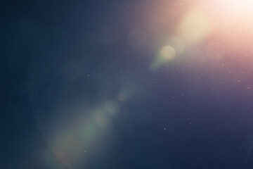 abstract blue light background with shiny particles and lens flare