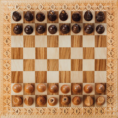 wooden chess pieces on the chessboard, top view