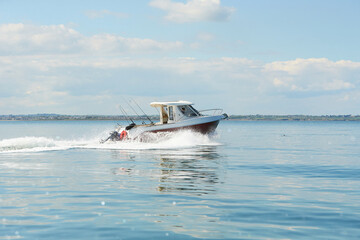 Fast boat on wavy blue sea. luxury motor boat in navigation