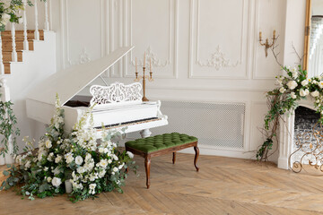 white piano in a bright room. white room interior