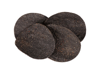 Black potato chips isolated on white background. Black chips with activated charcoal and red pepper.