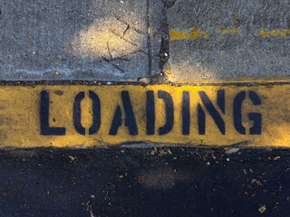 Loading sign written on street pavement