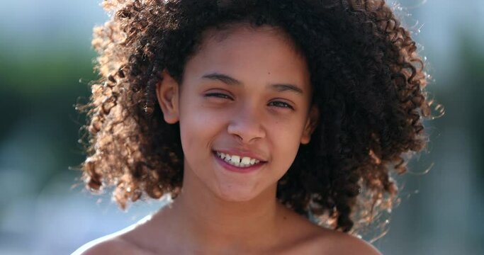 Beautiful preteen girl child portrait smiling outside, black African descent