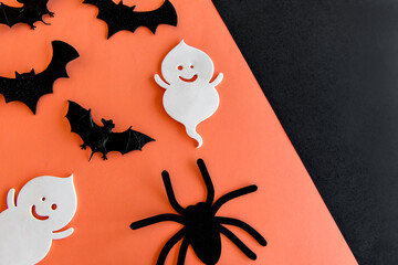 Happy Halloween decoration. Bats and ghost on orange background.
