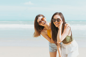 Two women friends in summer casual clothes Take a photo together at the beach