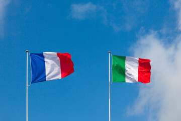 France flag and Italy flag are isolated on blue sky. Concept cooperation in Europe - 442433118