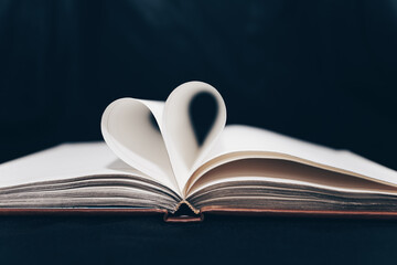 expanded diary with heart-shaped pages. notebook on a black background. love of books