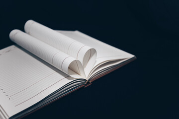 expanded diary with heart-shaped pages. notebook on a black background. love of books