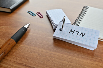 There is a card with the word of MTN which is an abbreviation for medium term note on the desk with...