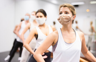 Group of multiethnic dancers training in masks during COVID-19 .pandemic.